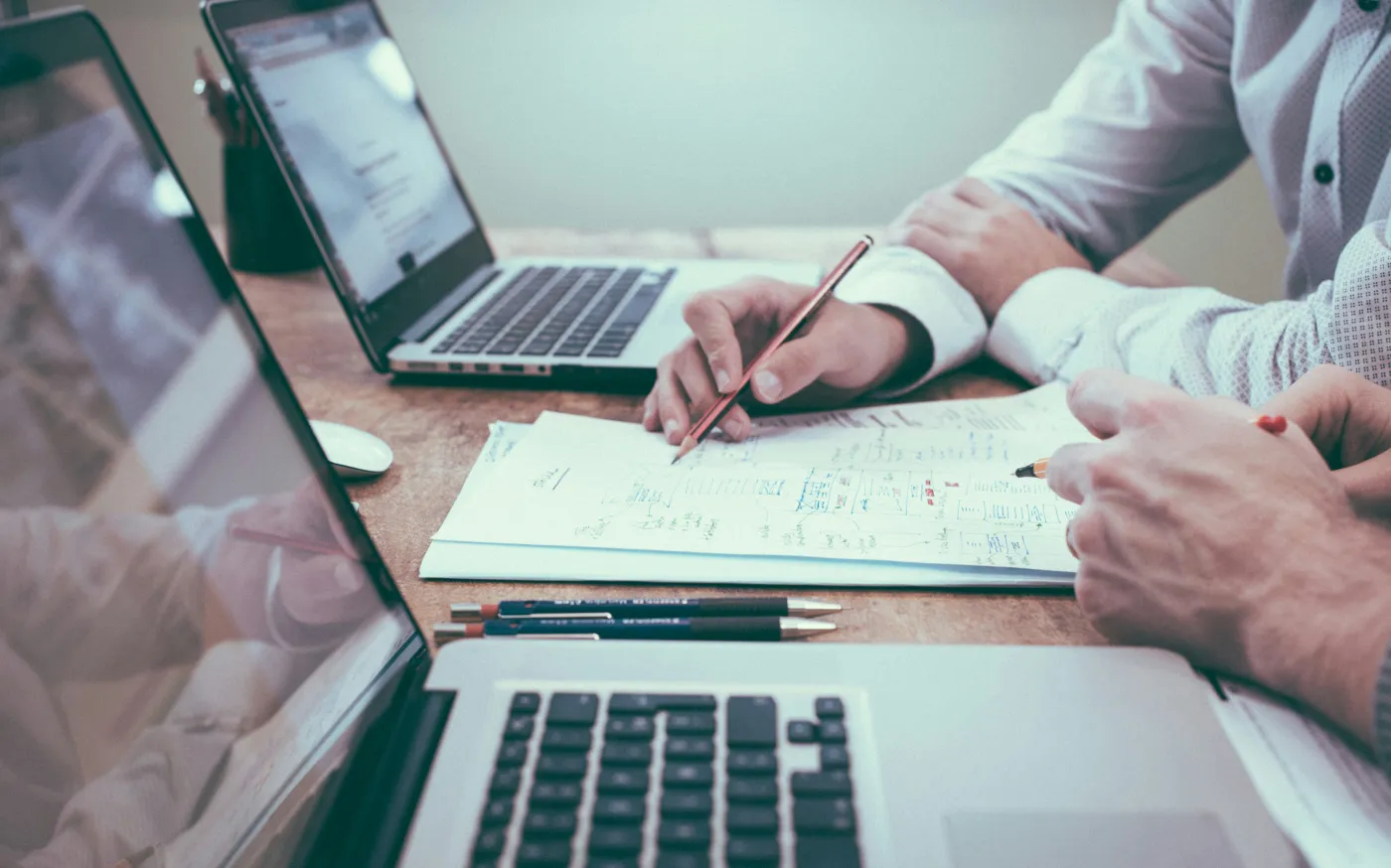 person holding pencil near laptop computer by Scott Graham courtesy of Unsplash.